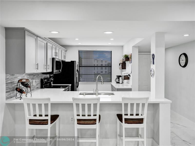 a kitchen with stainless steel appliances a refrigerator and a stove top oven