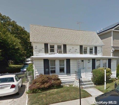 a view of a car parked in front of a brick house