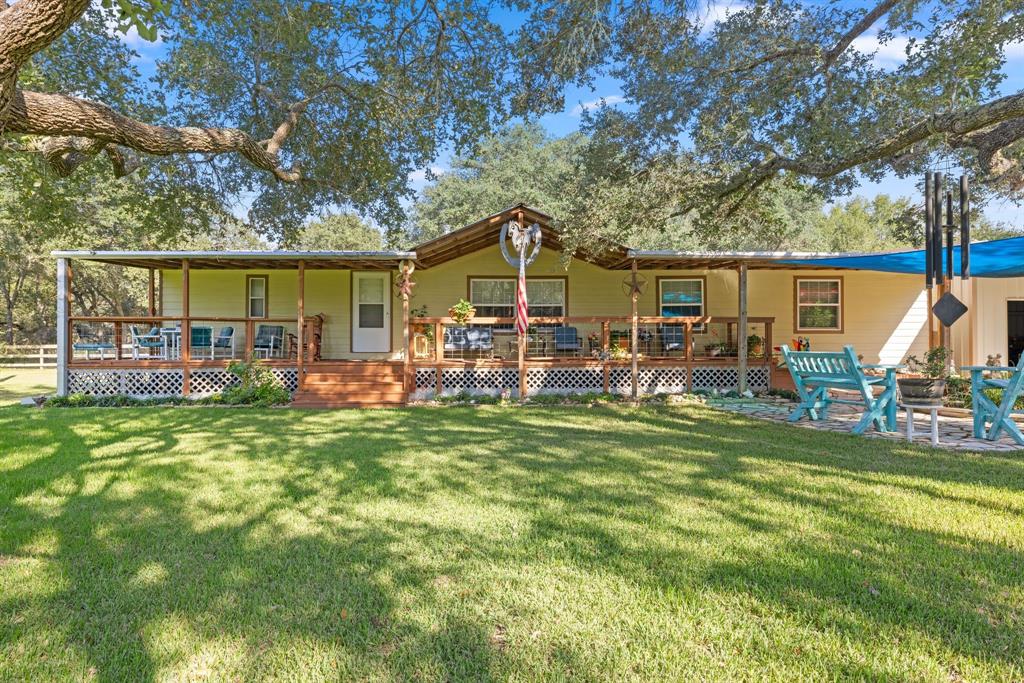 a front view of house with yard outdoor seating and green space