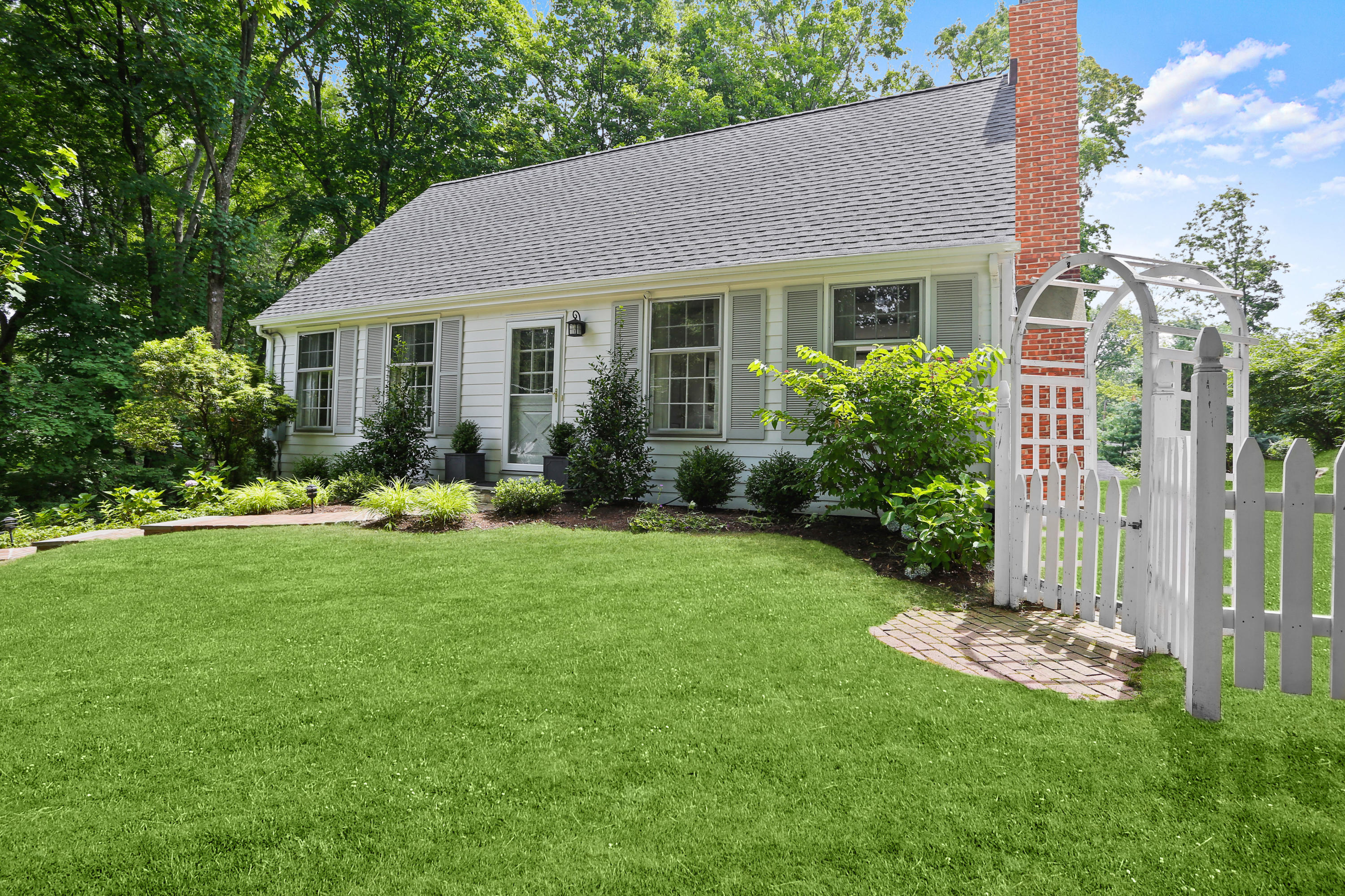 a front view of a house with a yard and porch