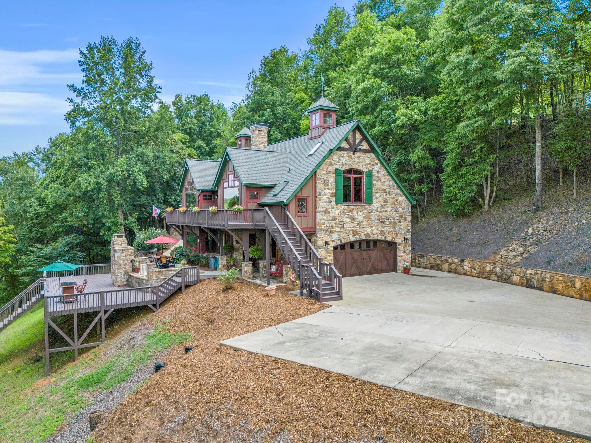 a view of a house with a patio and a yard