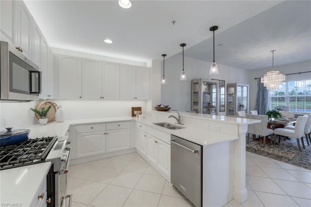 a kitchen with a sink window and stainless steel appliances