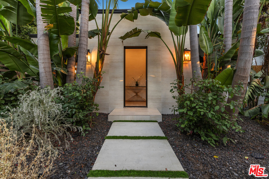 a view of a pathway both side of the house