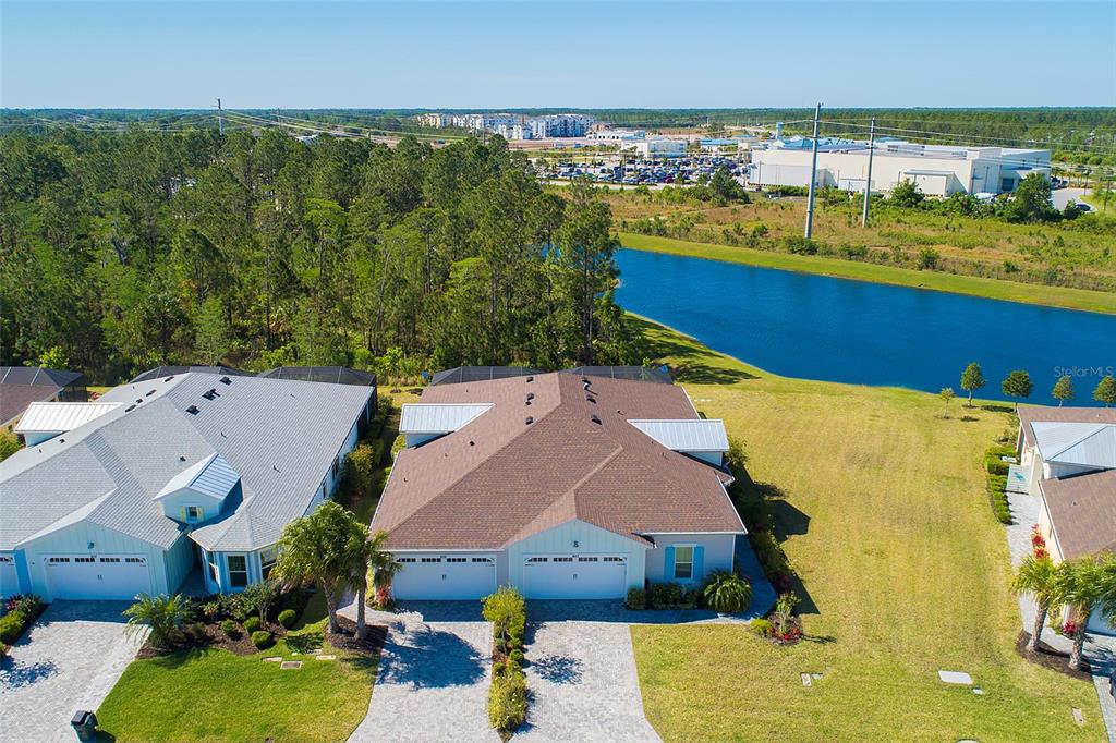 an aerial view of residential houses with outdoor space and swimming pool