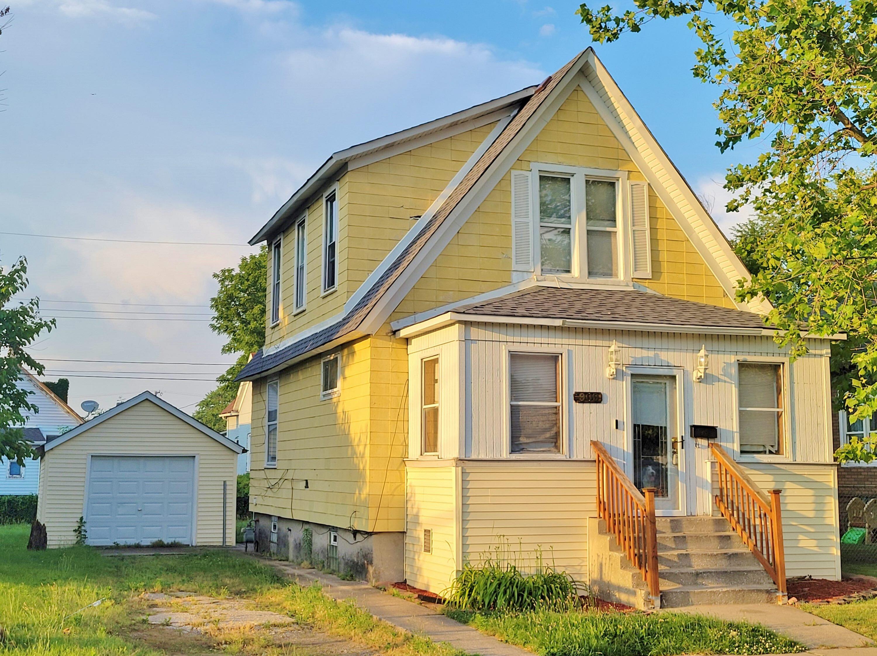 a view of a house with a small yard and wooden fence