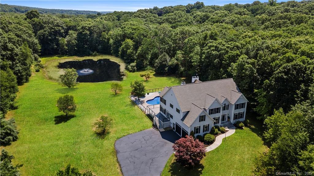 an aerial view of a house with big yard