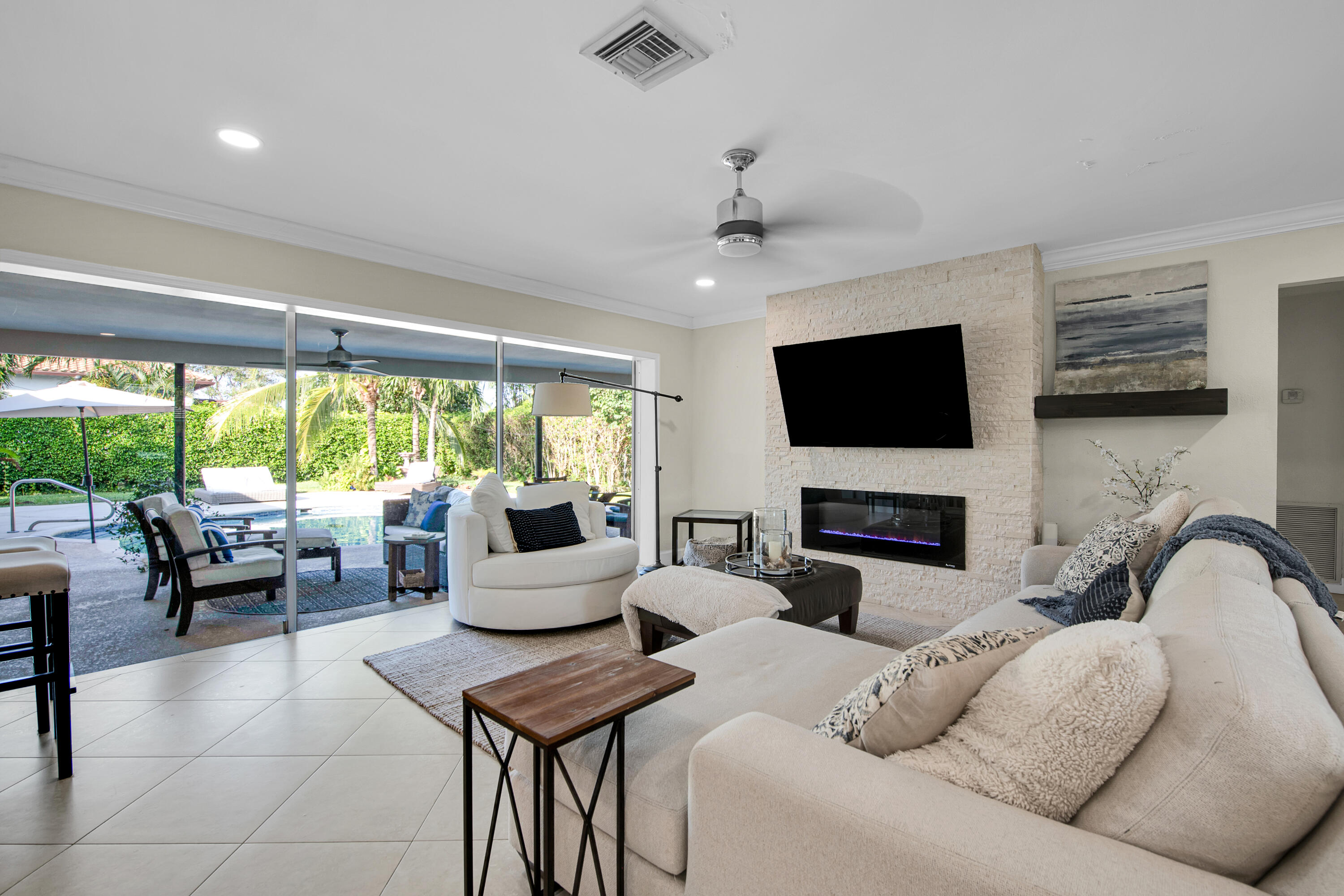 a living room with furniture a fireplace and a flat screen tv