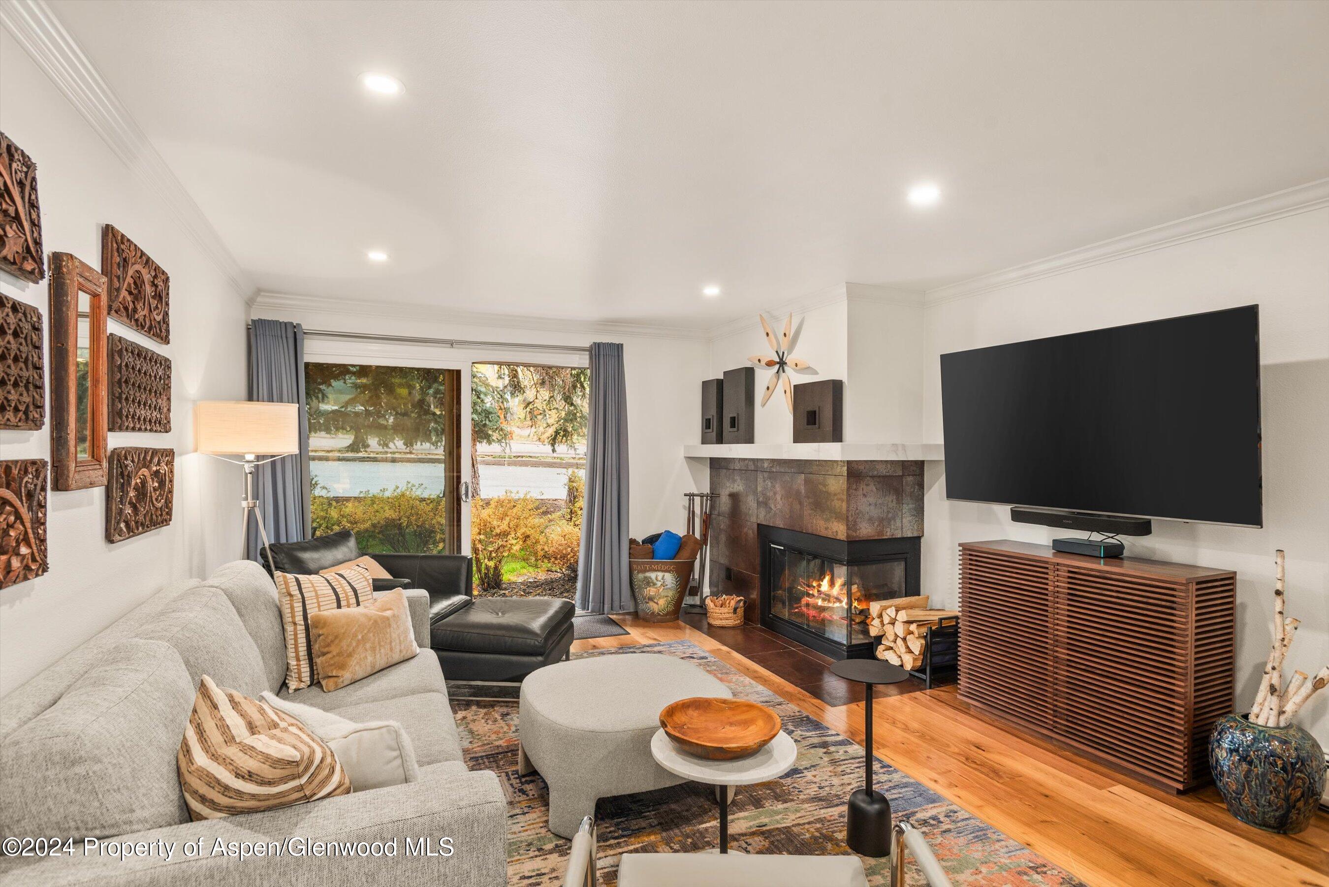 a living room with fireplace furniture and a flat screen tv