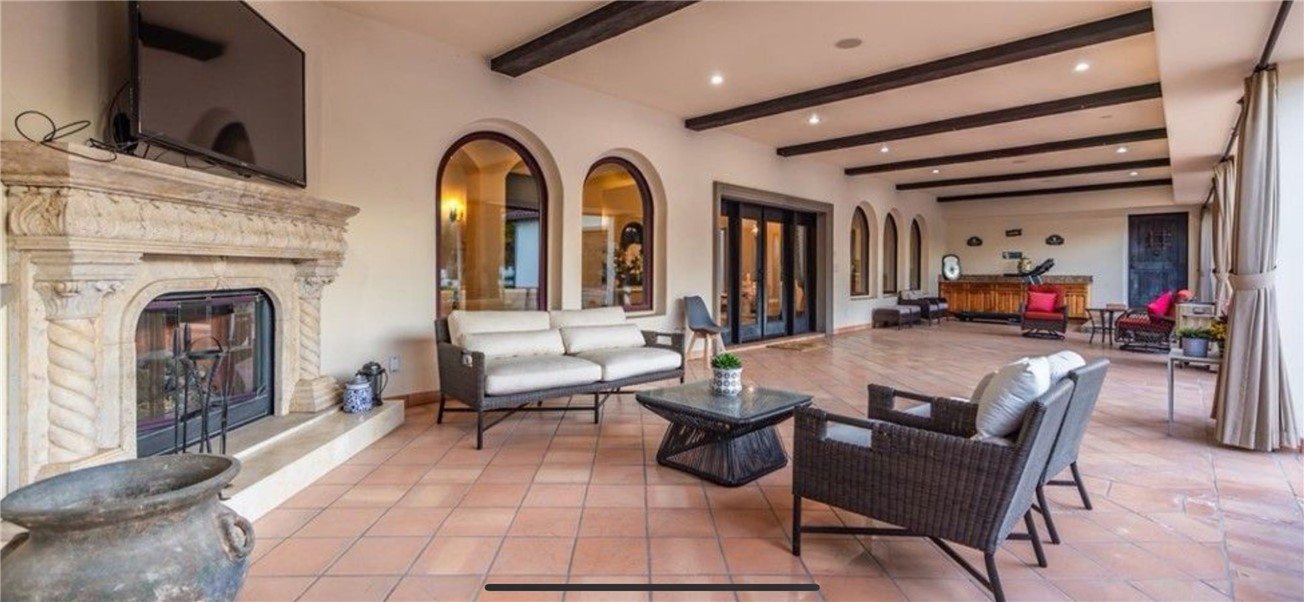 a living room with fireplace furniture and a fireplace