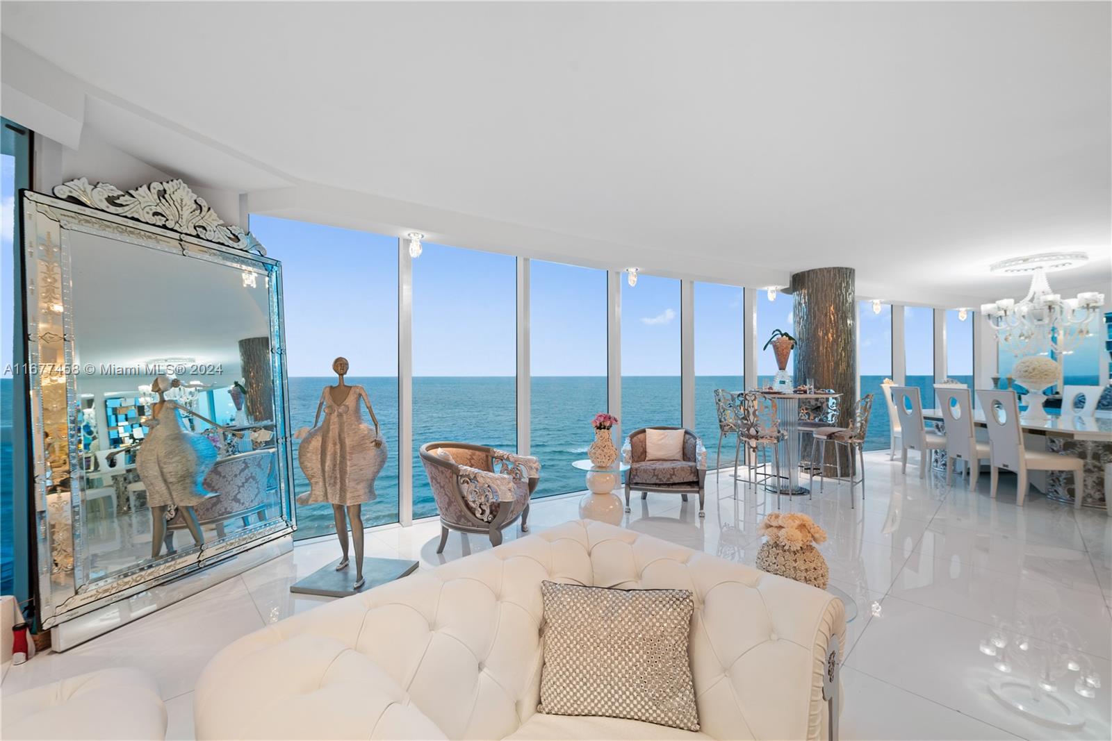 a living room with lots of furniture and a chandelier