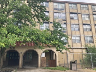 a front view of a building with garden