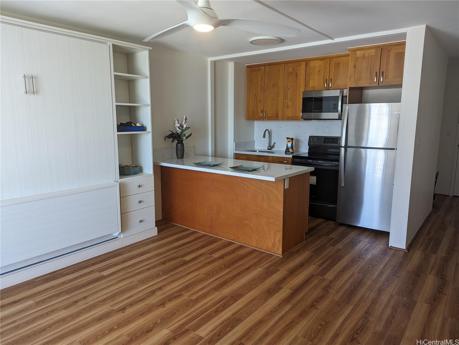 Unit features upgraded kitchen cabinets and quartz counter tops, stainless steel appliances, vinyl plank flooring, lighting and Murphy bed.