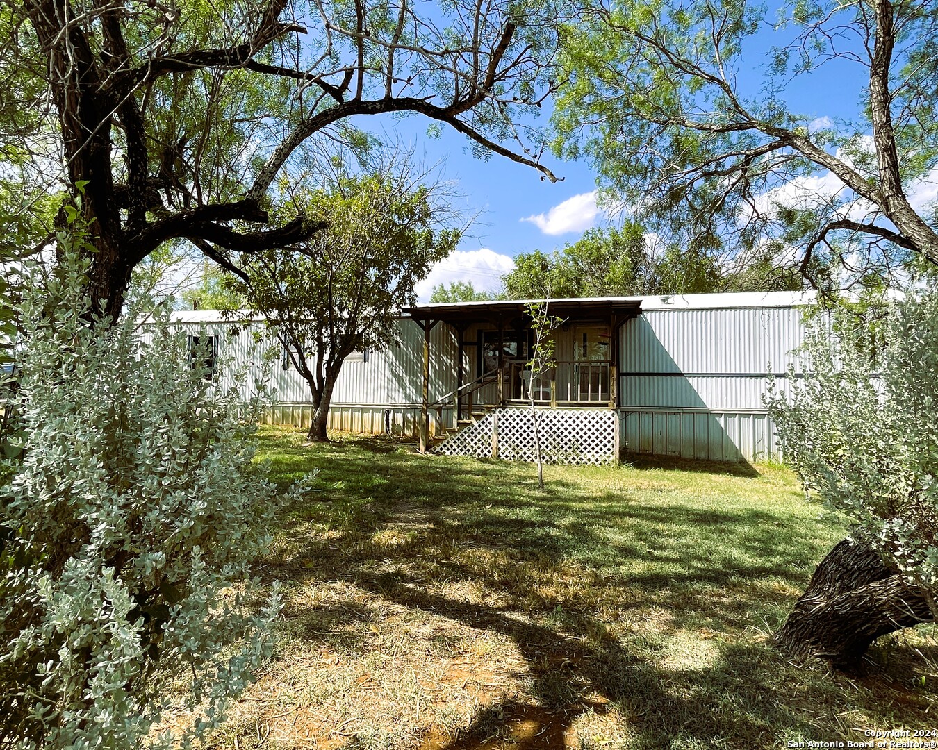 a view of a house with a small yard