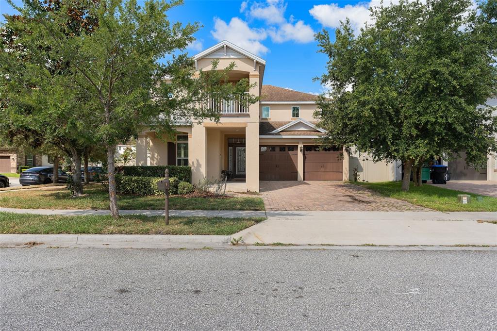 a front view of a house with a yard and a garage