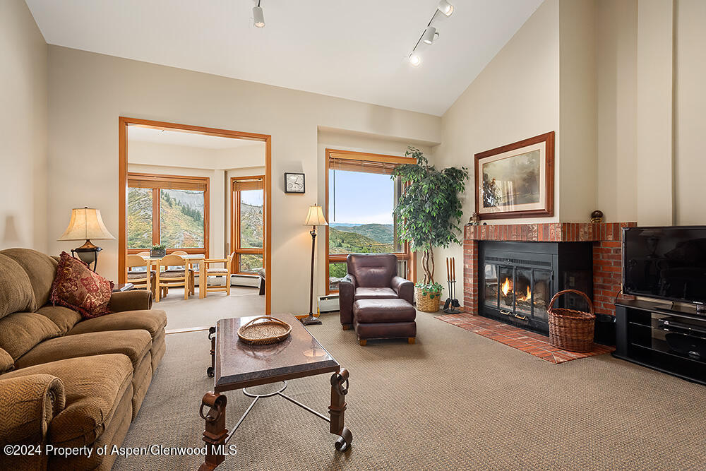 a living room with furniture fireplace and a flat screen tv