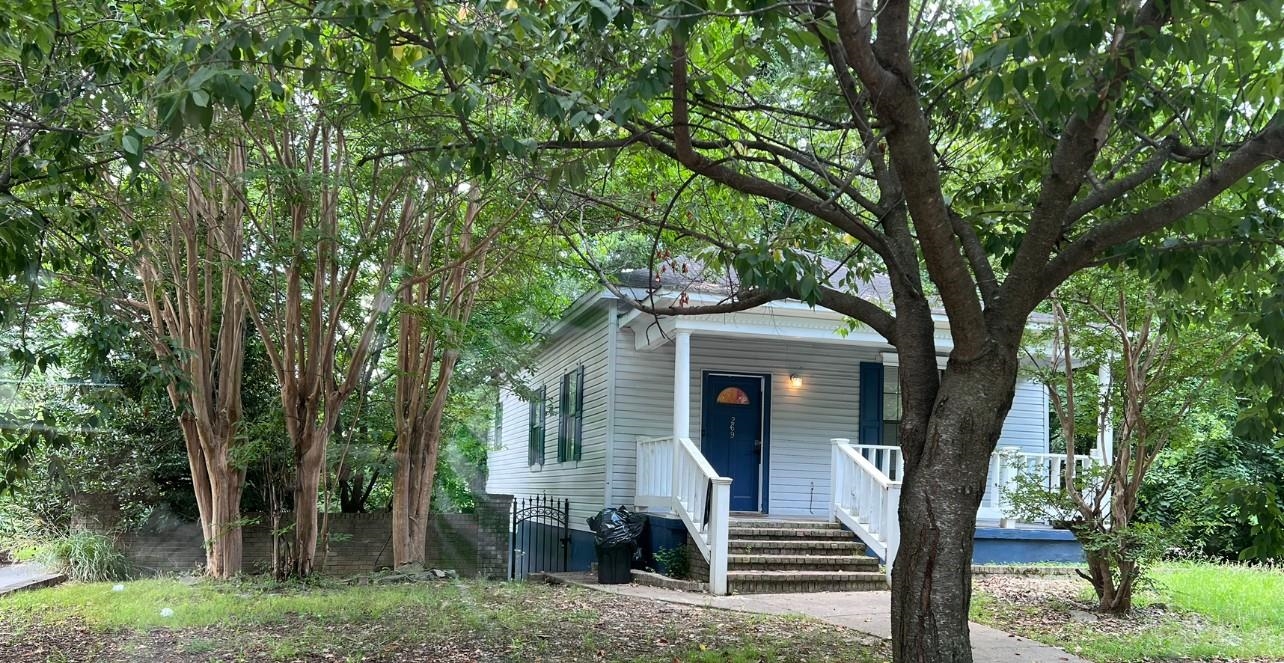 a front view of a house with garden