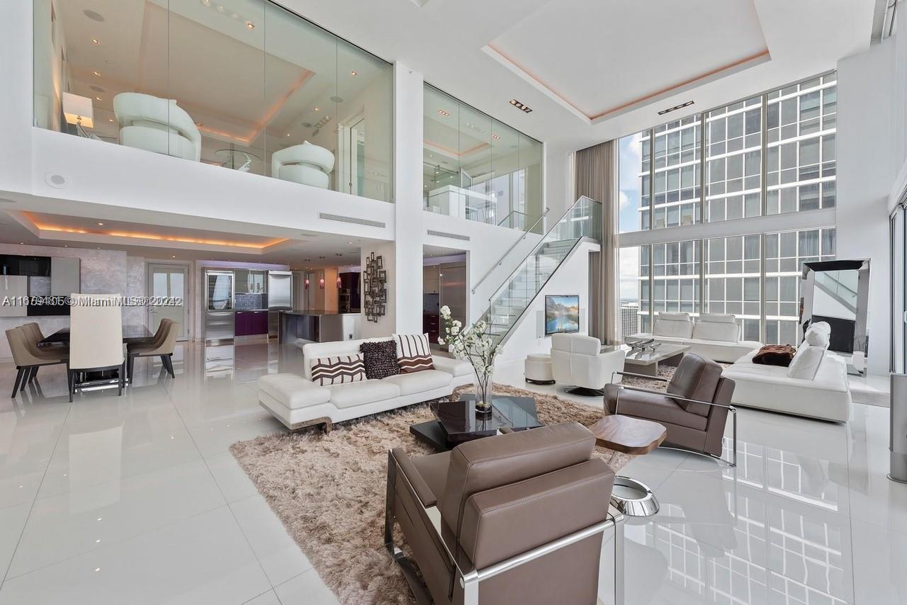 a view of living room with furniture and floor to ceiling windows