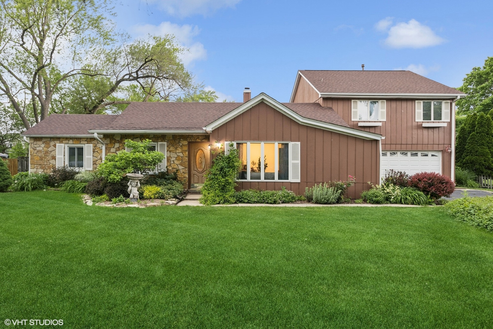 a front view of a house with a yard and porch