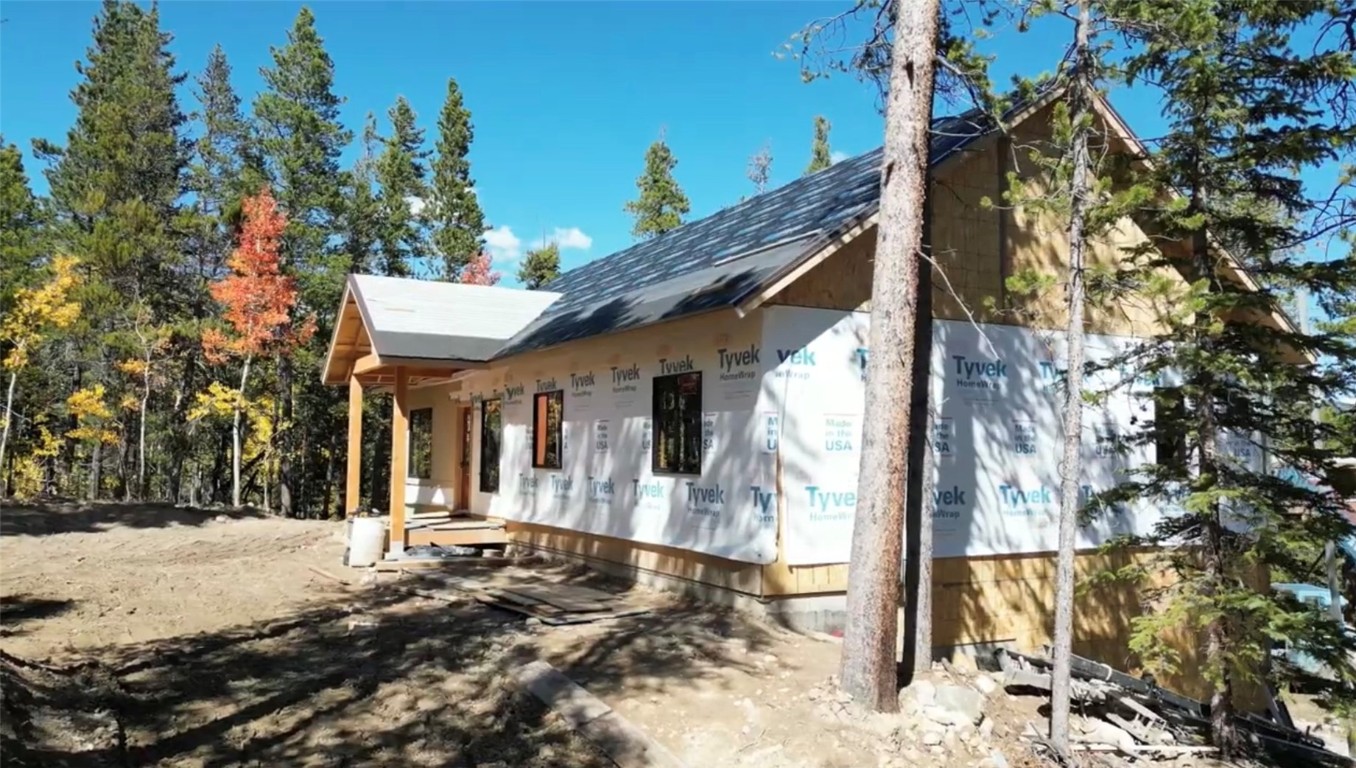 a view of a house with a yard covered with snow