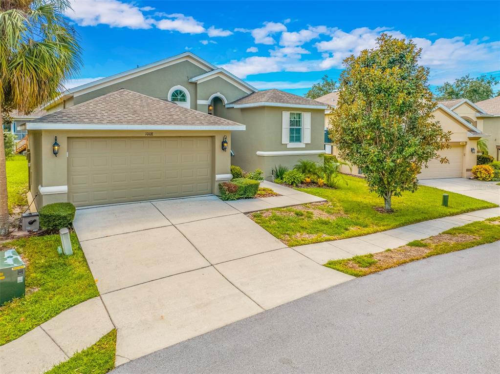 a front view of a house with a yard and garage