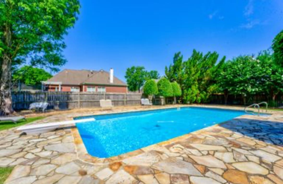 a view of a swimming pool with an outdoor space and seating area