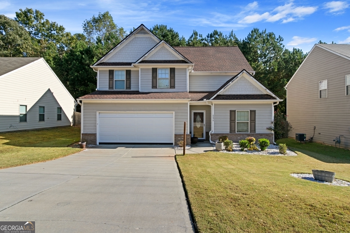 a front view of a house with garden