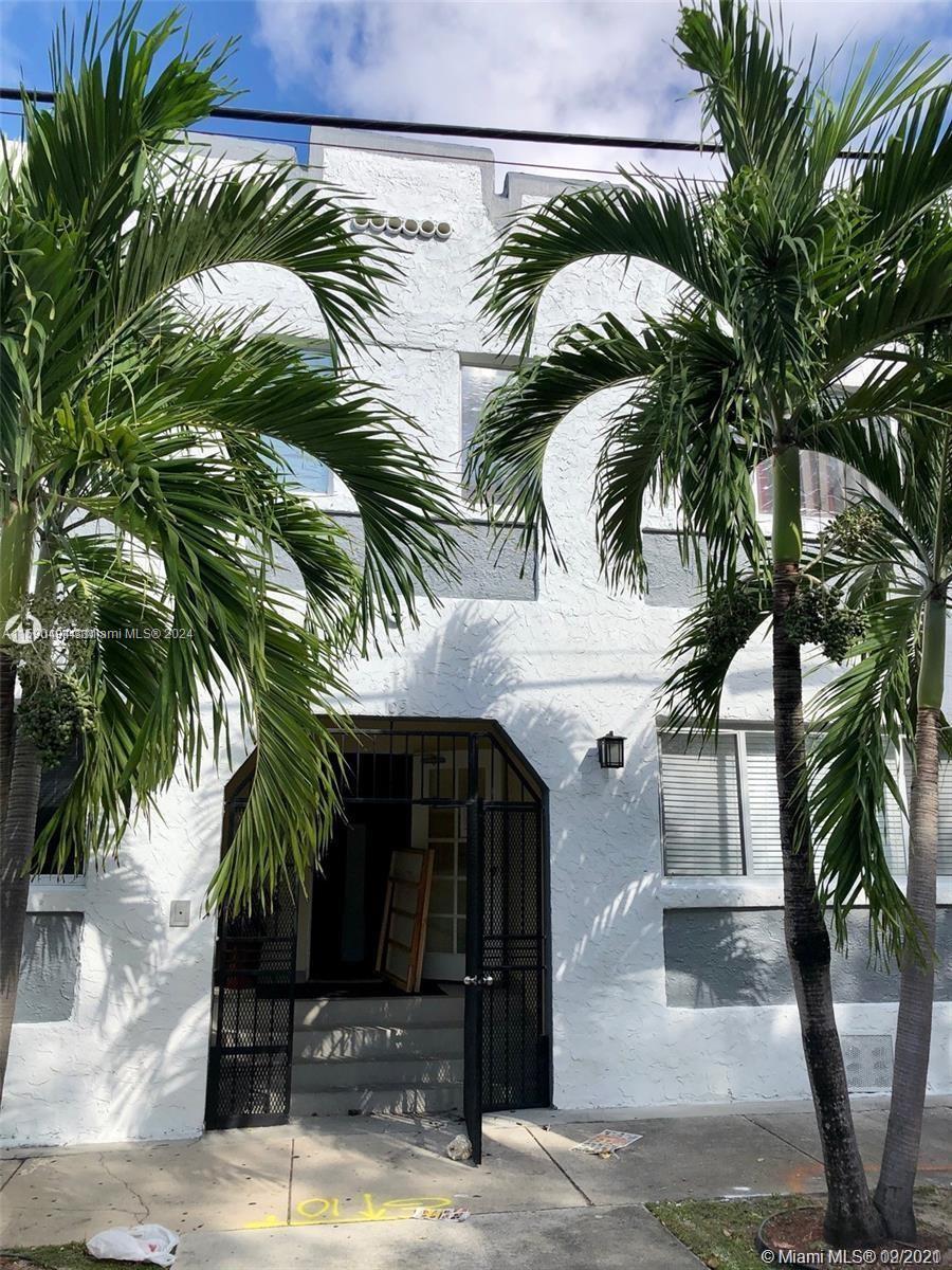 a view of a palm trees front of a house