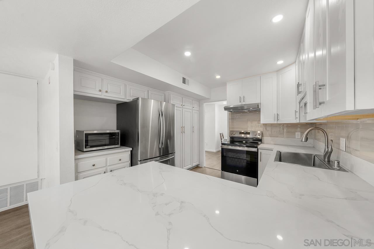 a large kitchen with a stove and a sink