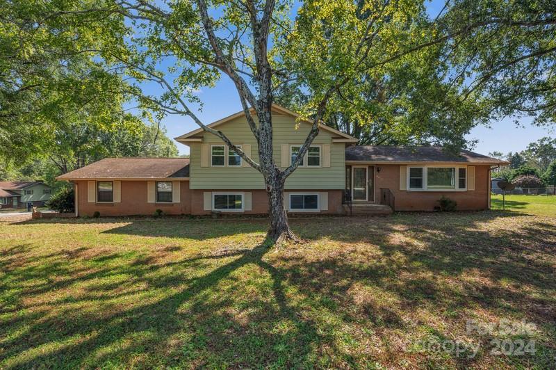 a house that has a tree in front of the house