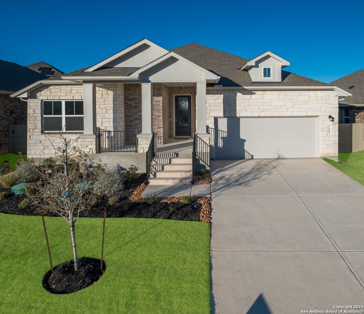 a front view of a house with a yard and garage