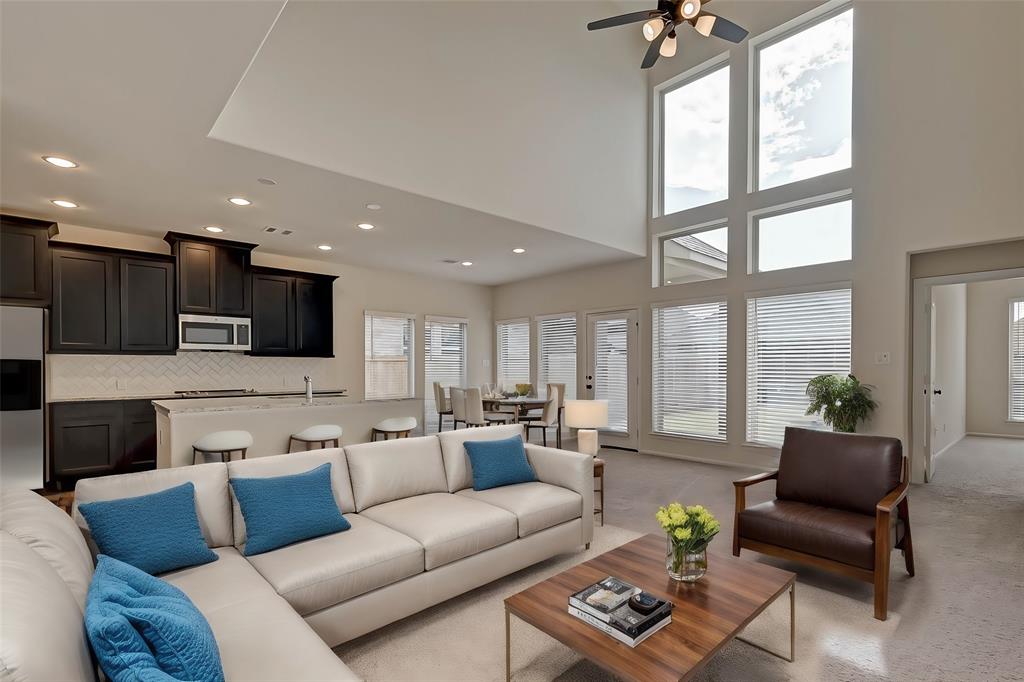 a living room with furniture wooden floor and a view of kitchen