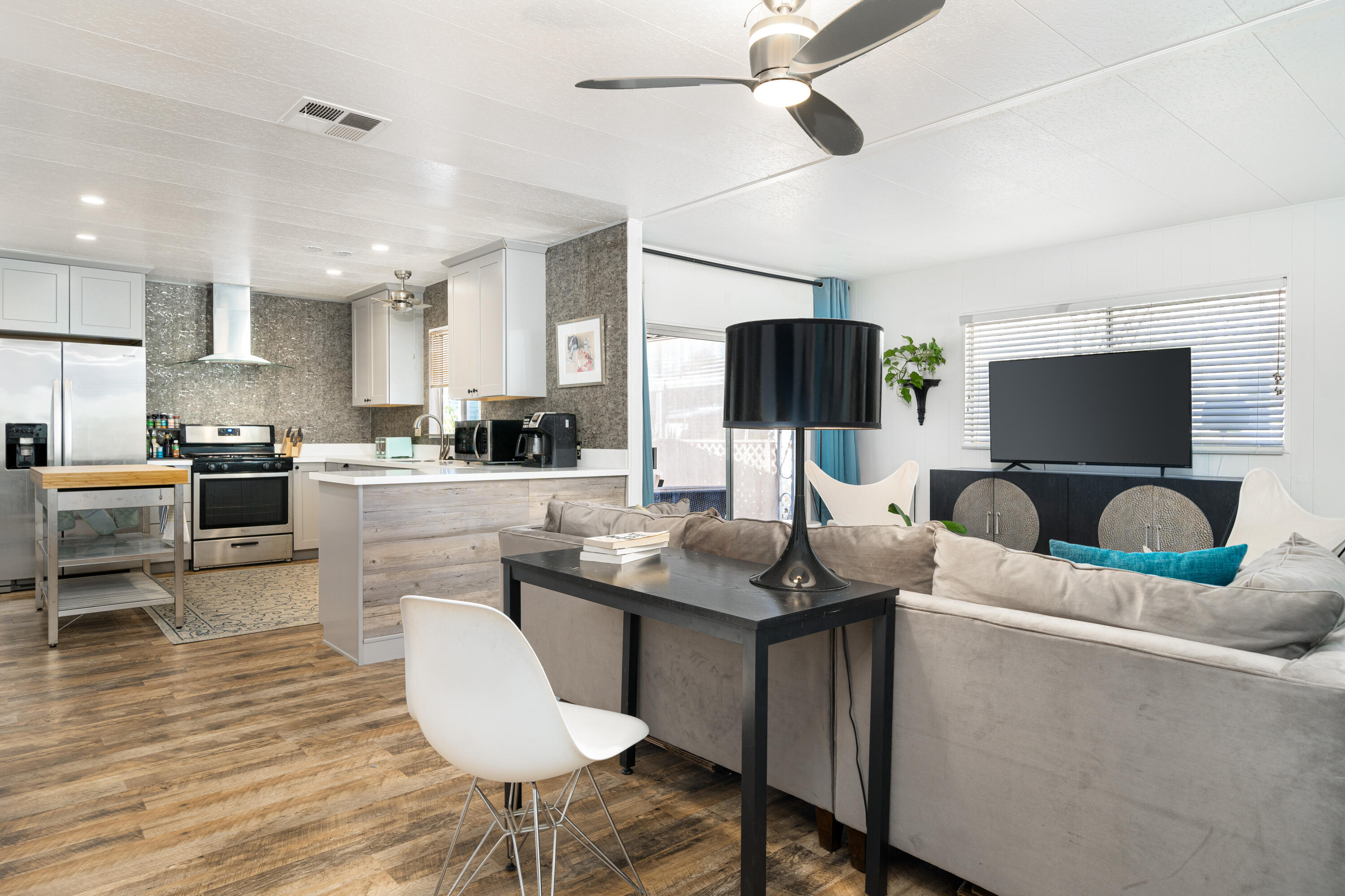 a kitchen with stainless steel appliances kitchen island granite countertop a sink and a refrigerator