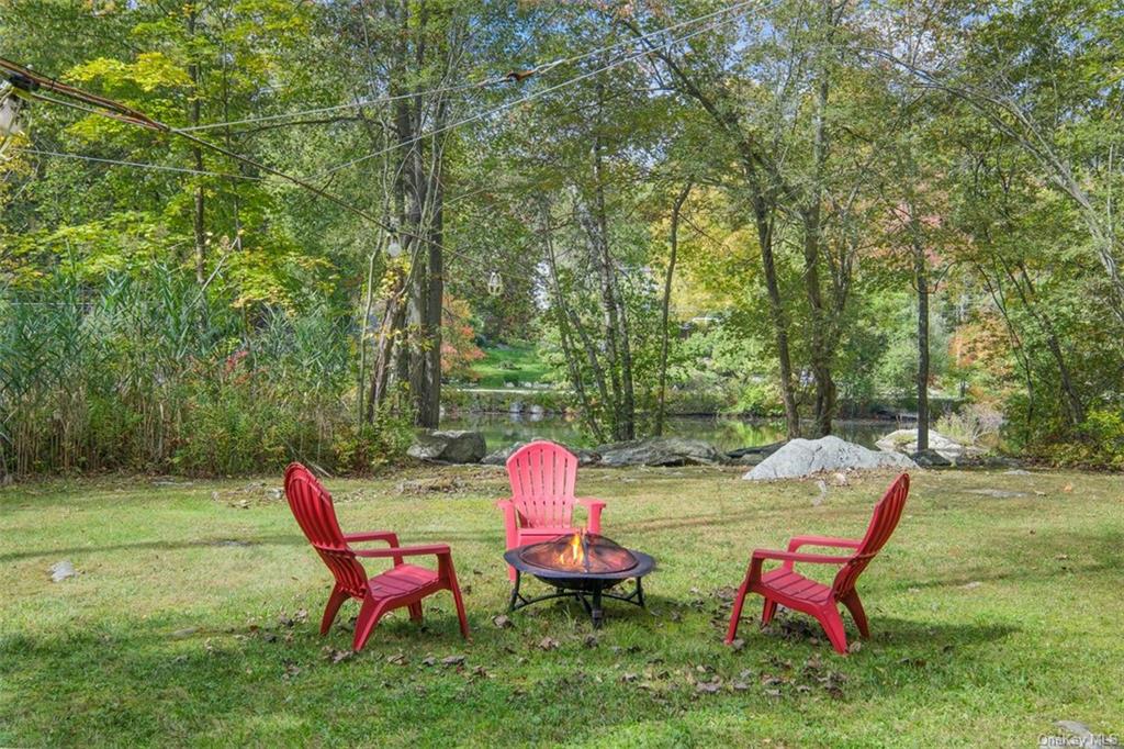 a view of a wooden chairs in backyard of the house