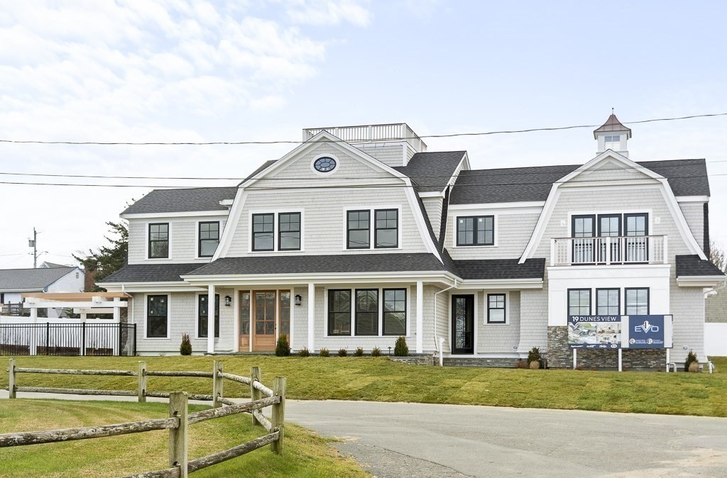 a front view of a building with a garden