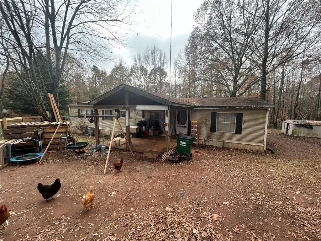 a view of a house with backyard space and sitting area