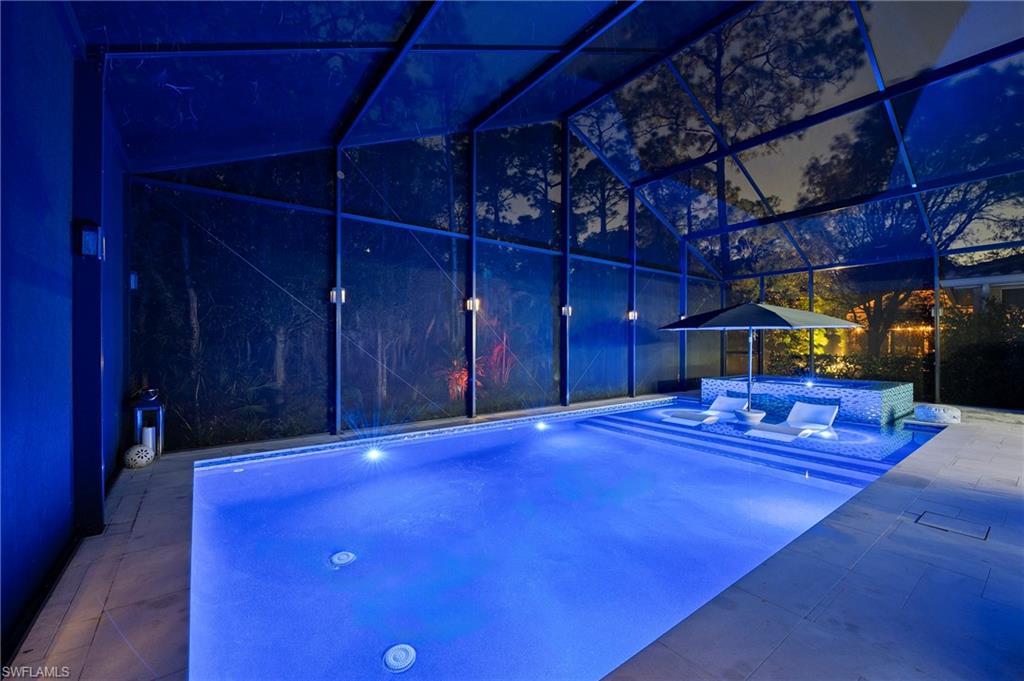 View of pool with an outdoor hangout area, a patio, a lanai, and an in ground hot tub