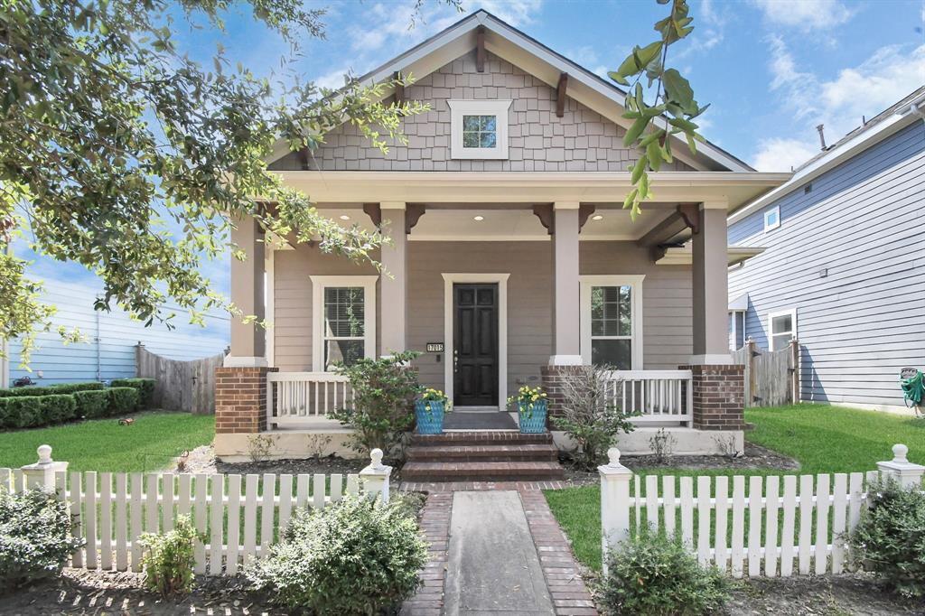 a front view of a house with a garden and plants