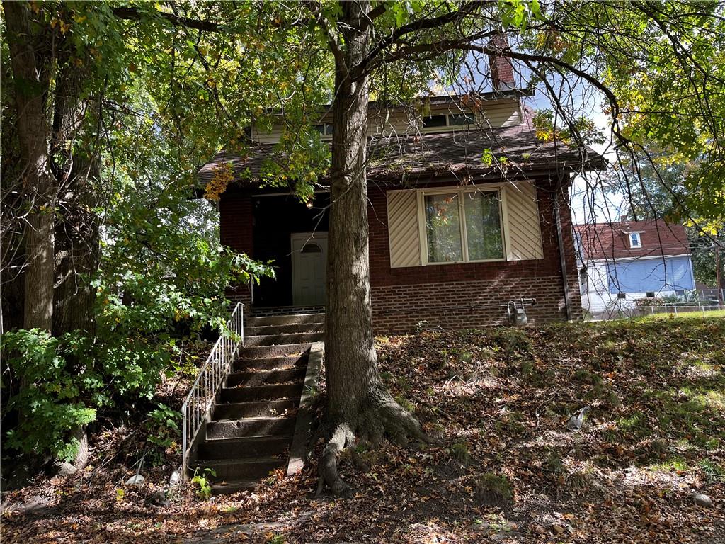 a view of a house with a tree