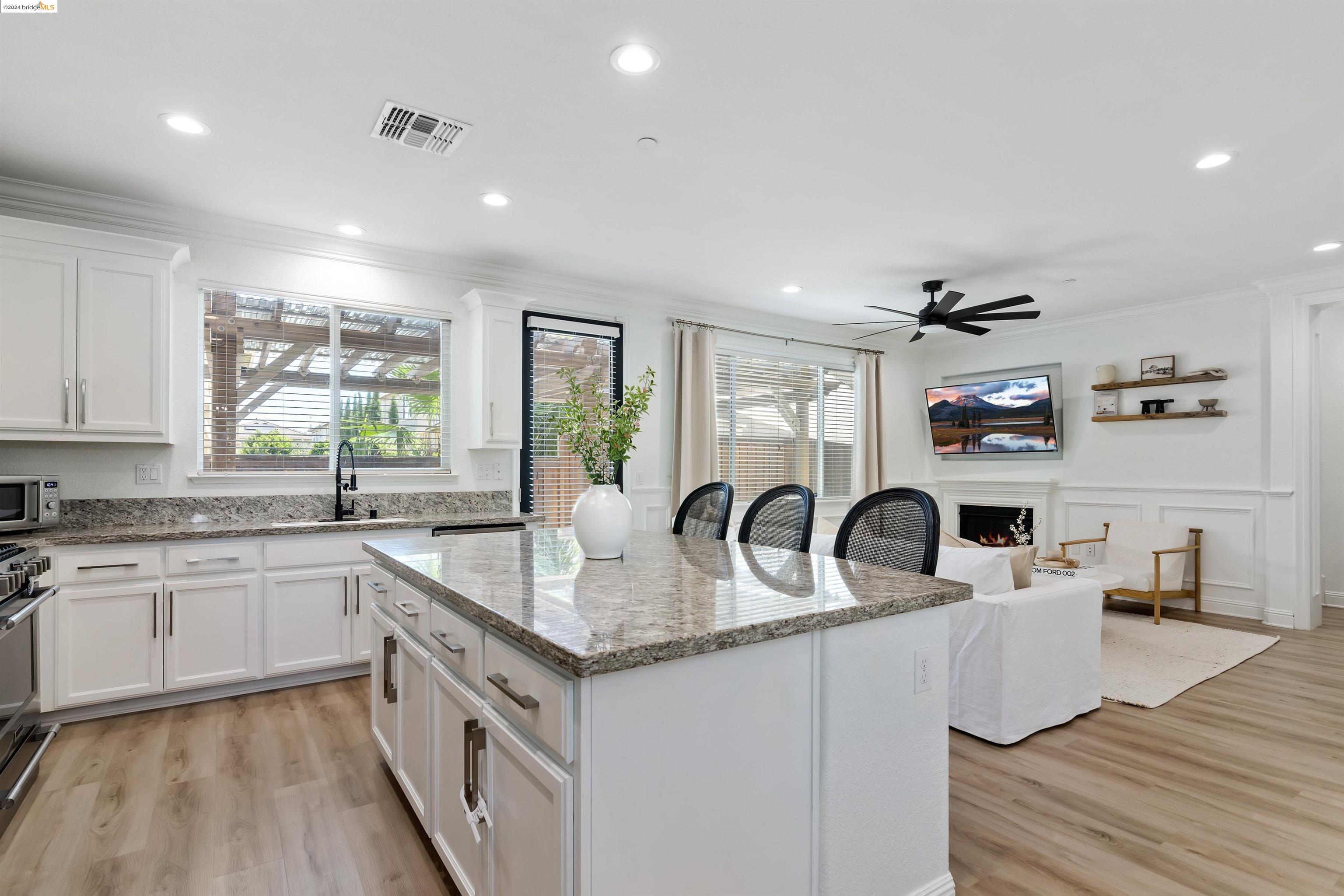 a kitchen with stainless steel appliances granite countertop a sink dishwasher and cabinets with wooden floor