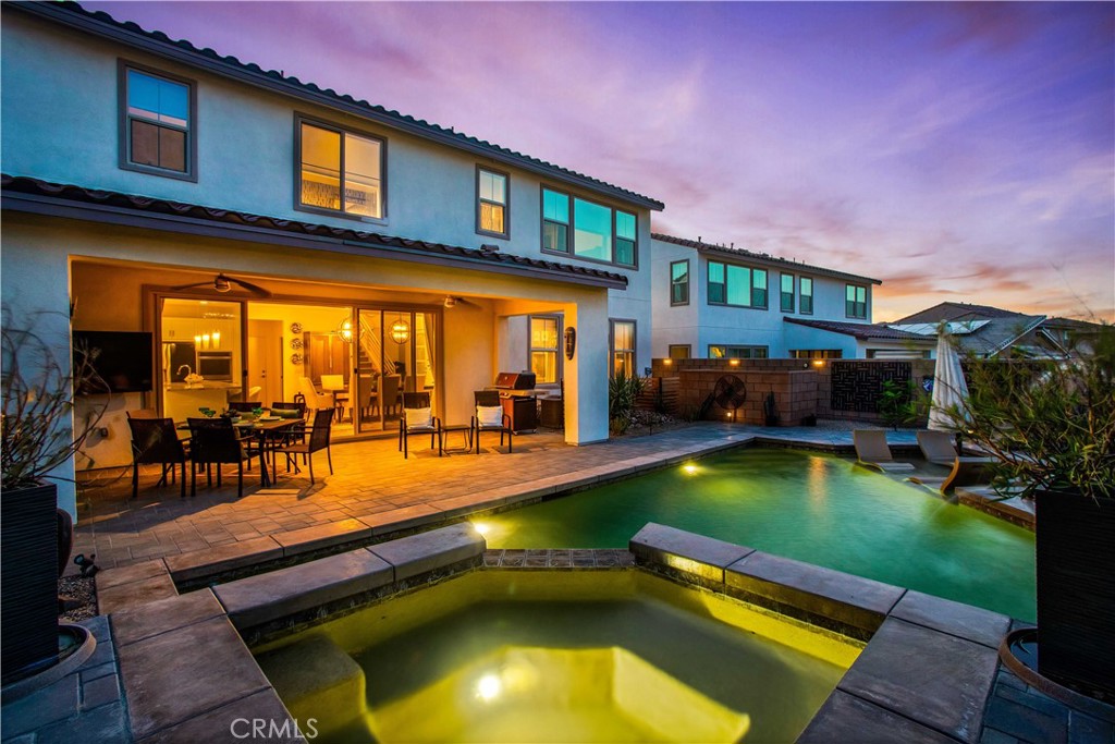 a swimming pool with outdoor seating and yard