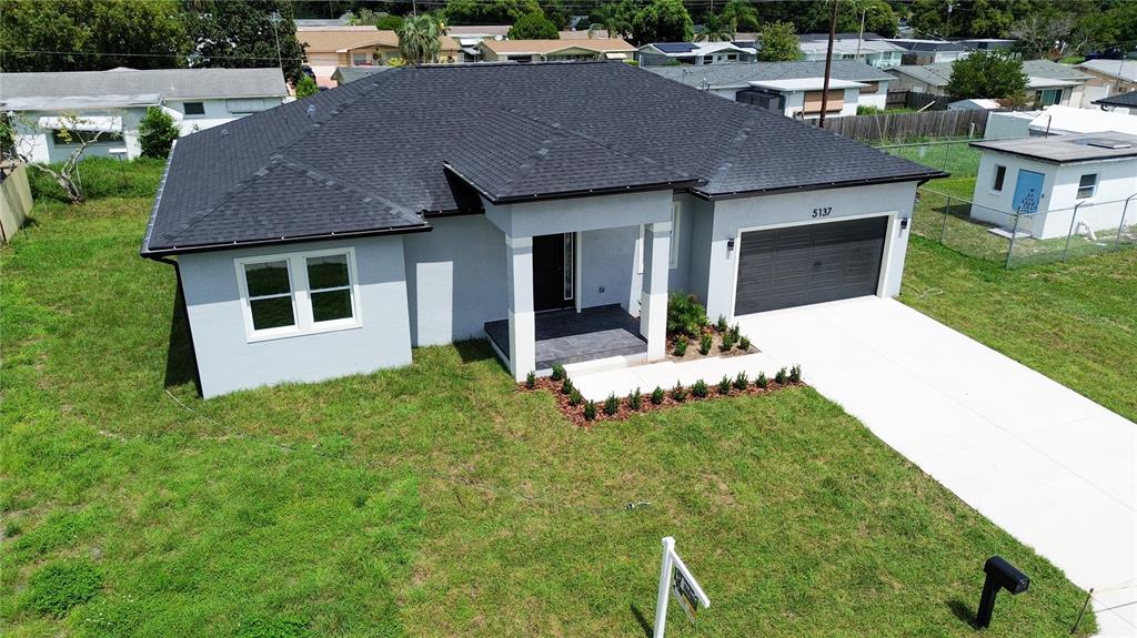 a aerial view of a house with table and chairs in patio