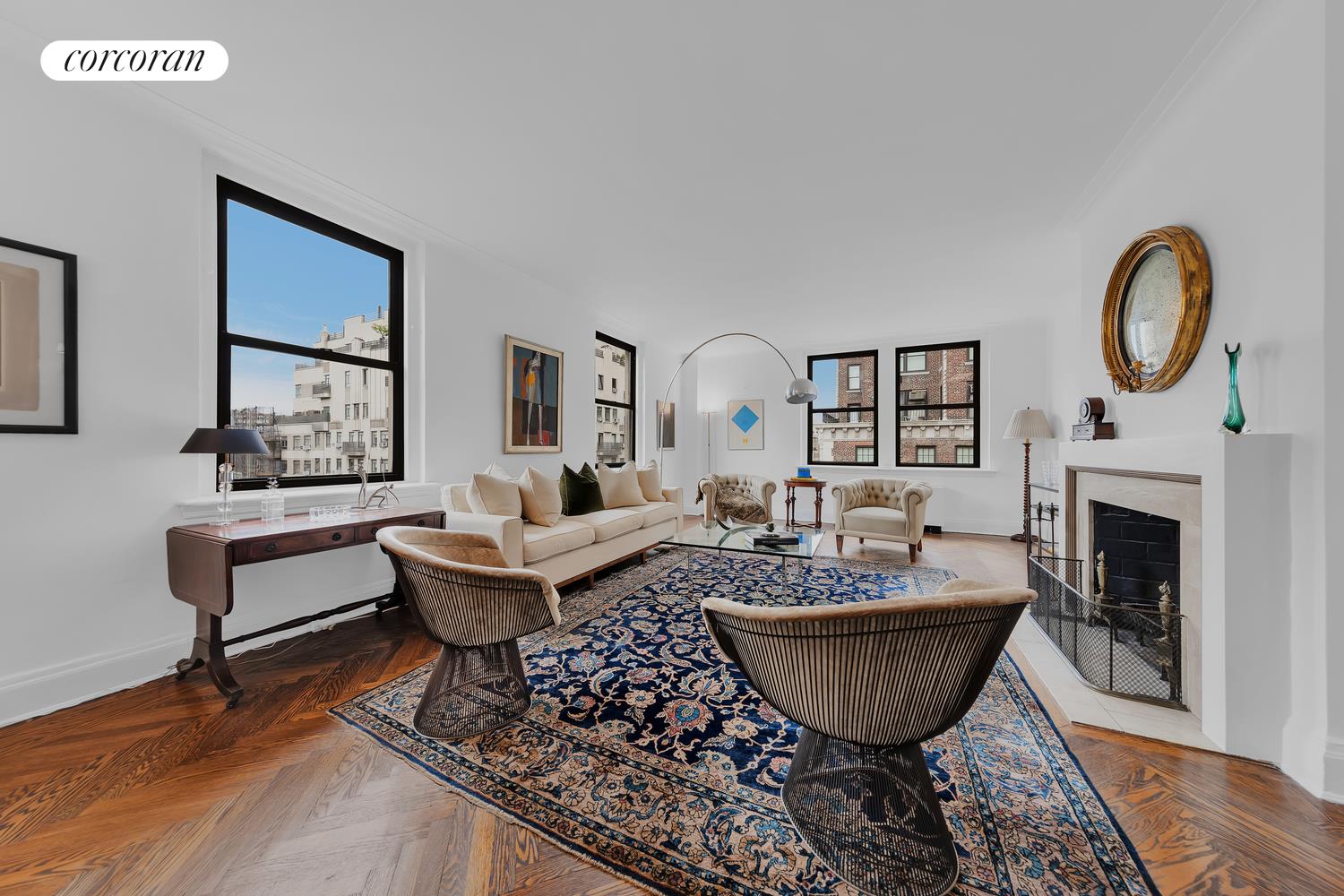 a living room with furniture a fireplace and wall paintings