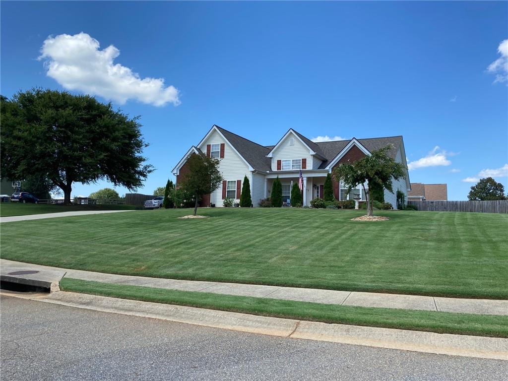 a front view of a house with a yard