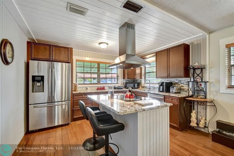 a kitchen with refrigerator and cabinets