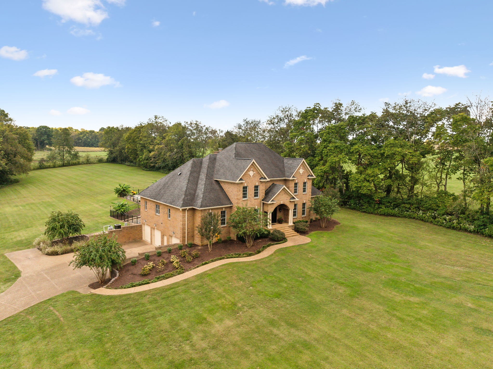 an aerial view of a house with swimming pool and garden