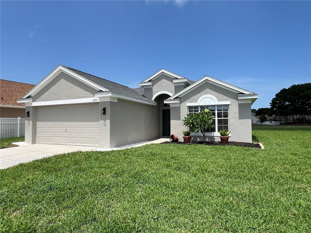 a front view of a house with a yard and garage