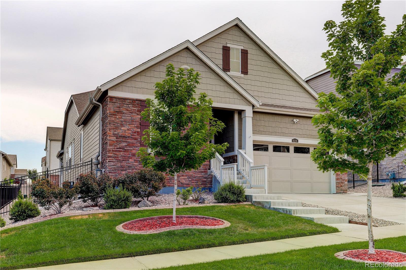 a front view of house with yard and green space