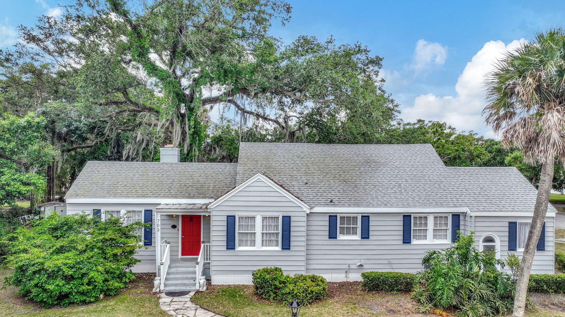 a aerial view of a house next to a yard