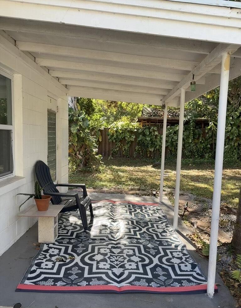 a living room with a rug floor to ceiling windows and a rug