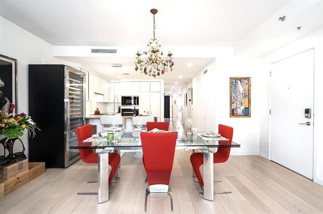 a view of a dining room with furniture and a chandelier